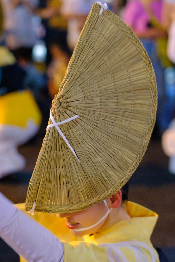 an awaodori dancer with her traditional hat