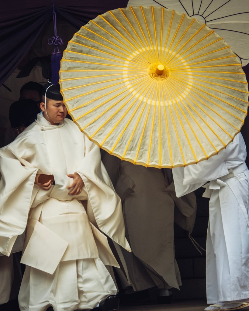 A priest receiving his traditional umbrella after the first part of the purification rite